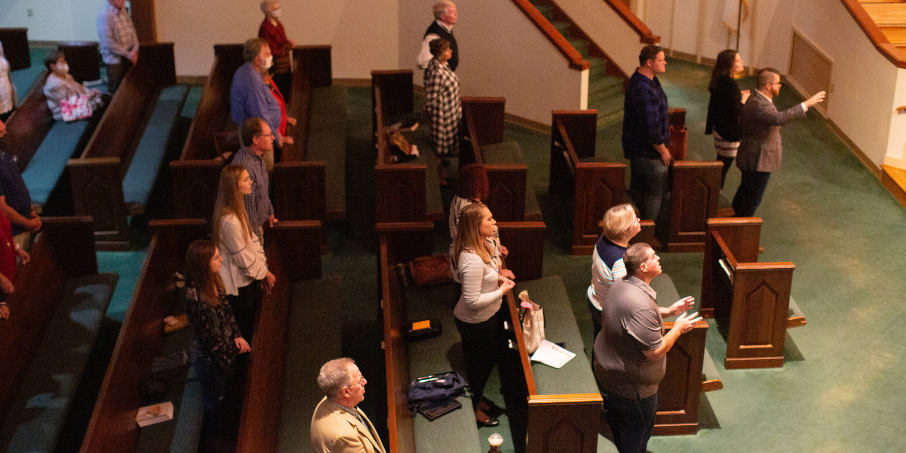 People worship in a sanctuary