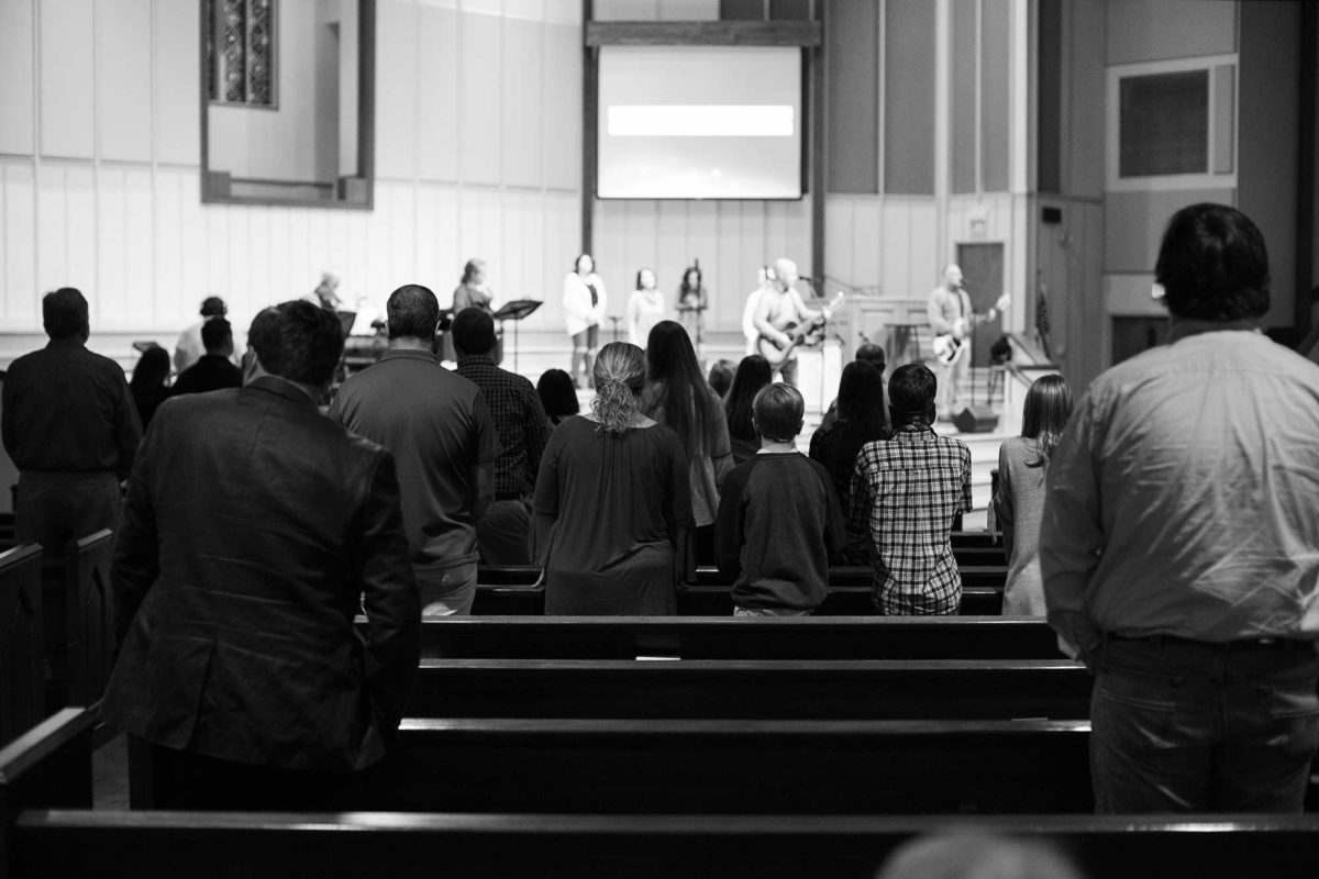 Black and white image showing a congregation from behind